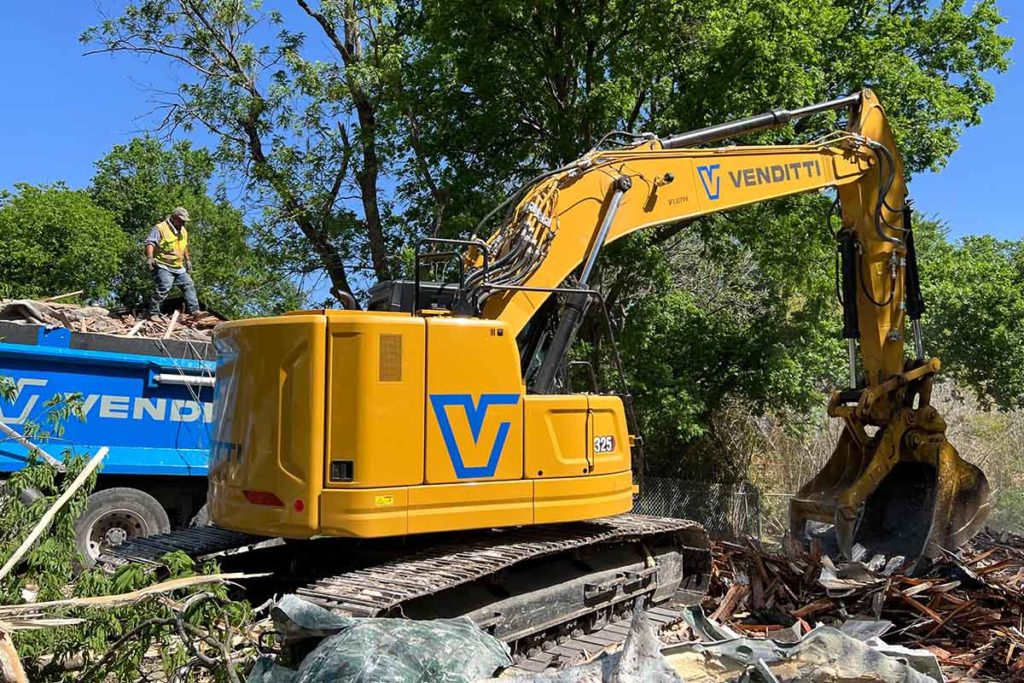 excavator assisting in debris removal